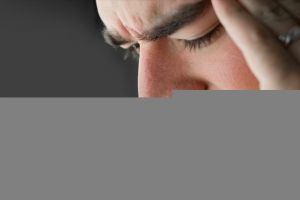 A young man that has an intense headache.